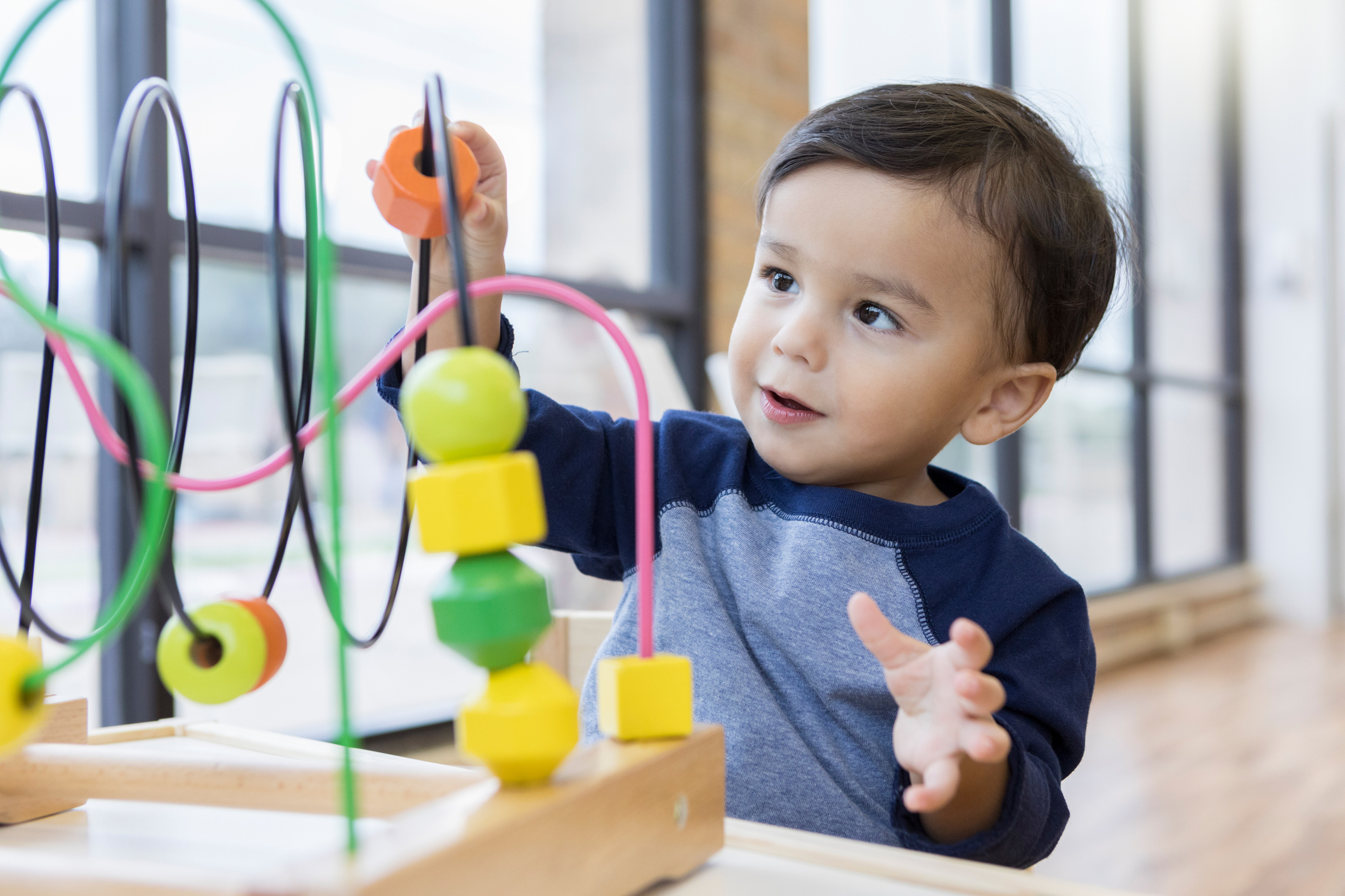 Little boy plays with toy at doctor's office