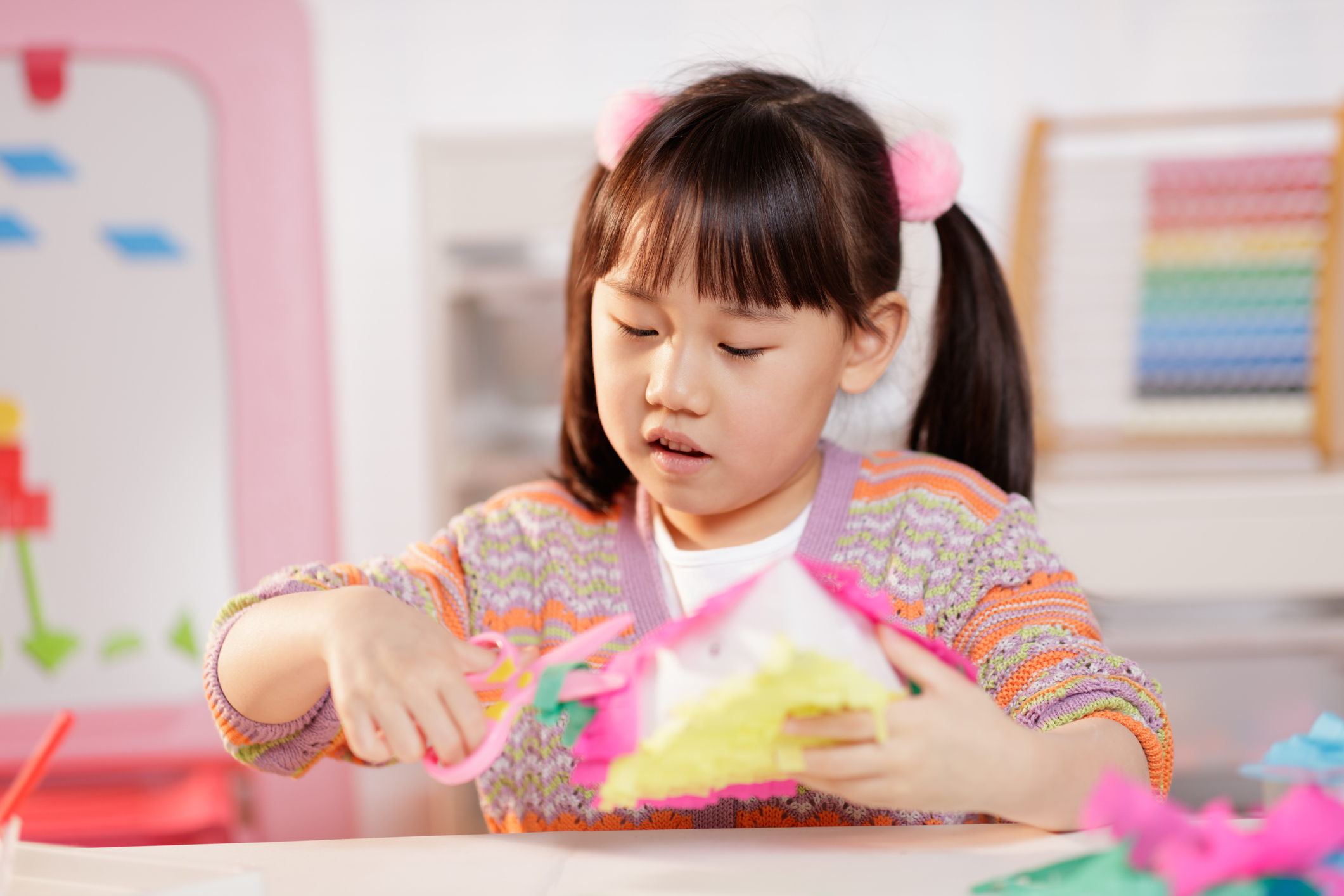 young girl making craft at home